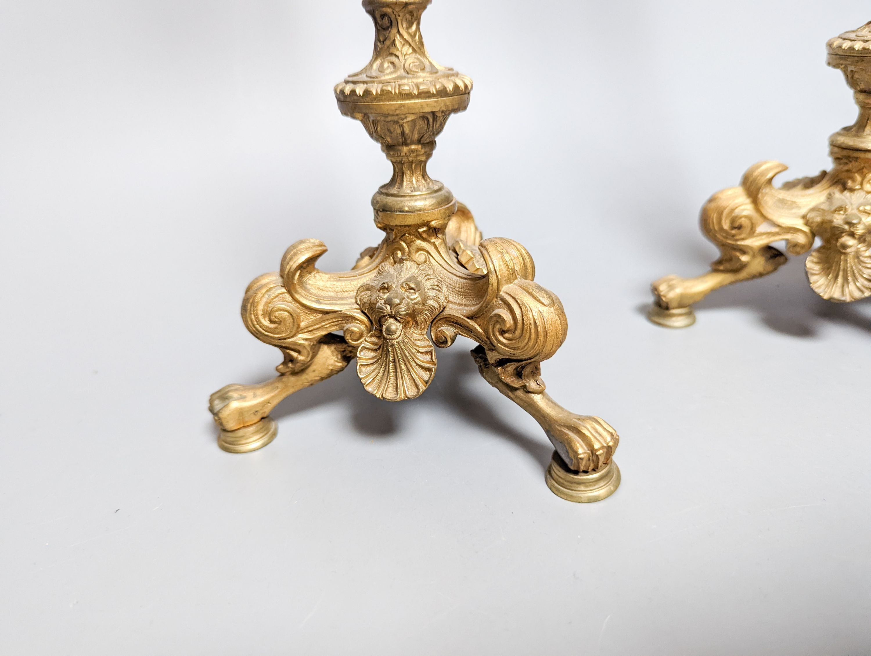 A pair of Empire style ormolu candlesticks and a pair of fire irons tallest 36cm
